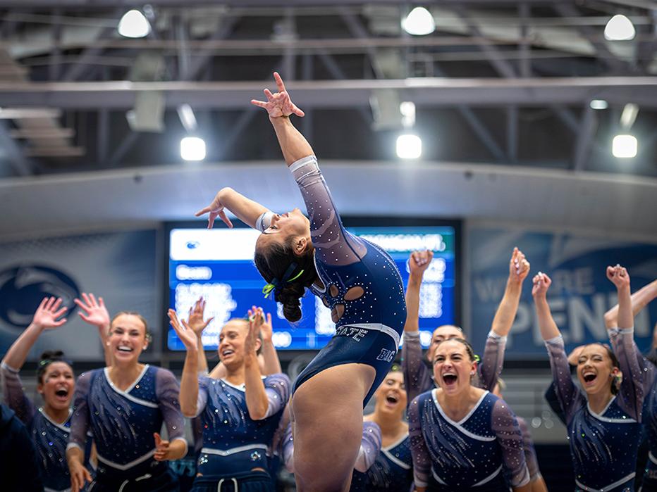 Gymnast celebrates with arms in air