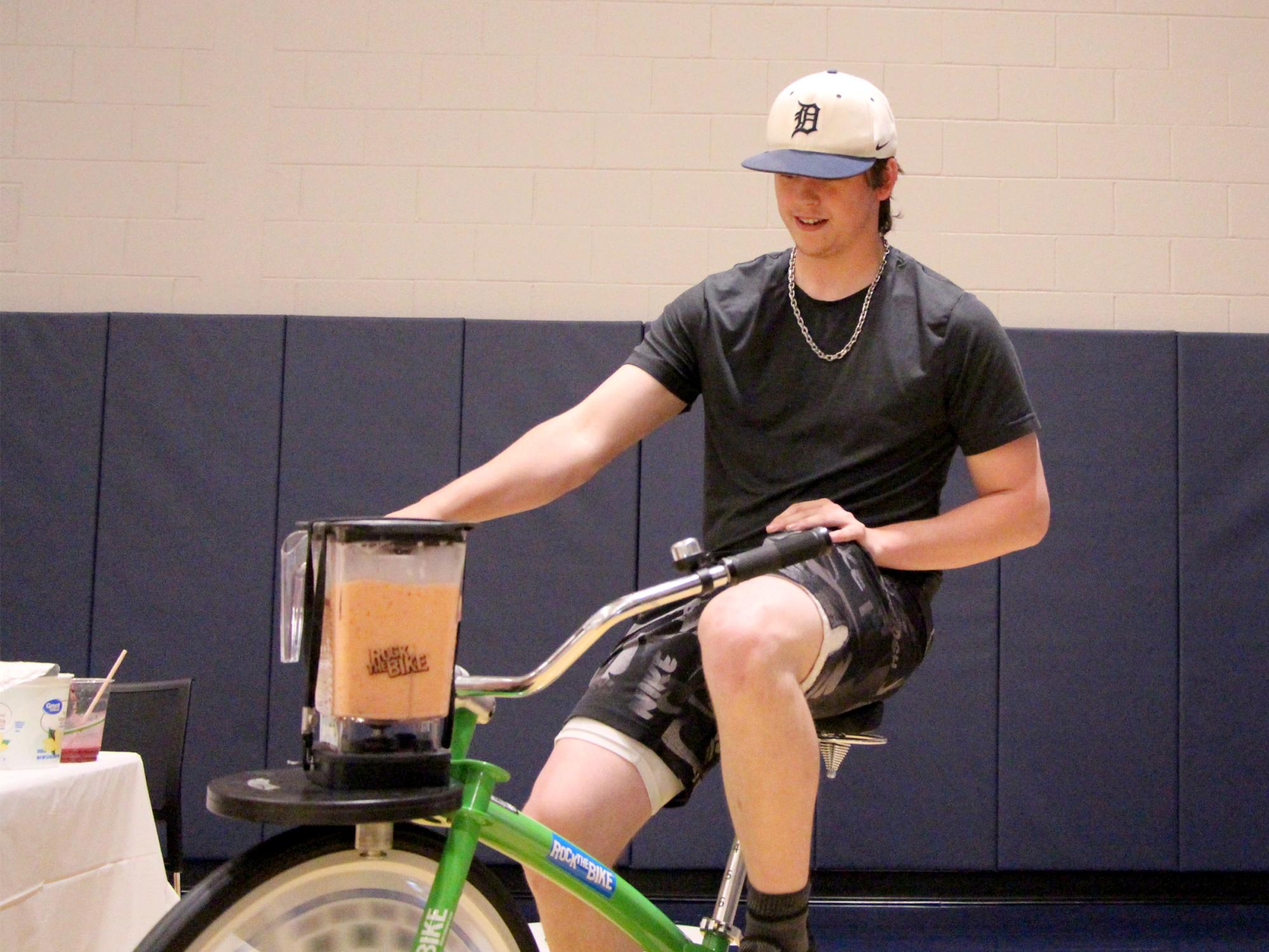 Penn State DuBois second year student Josh Ross makes himself a smoothie by using the smoothie bike during the earth day celebration at Penn State DuBois.