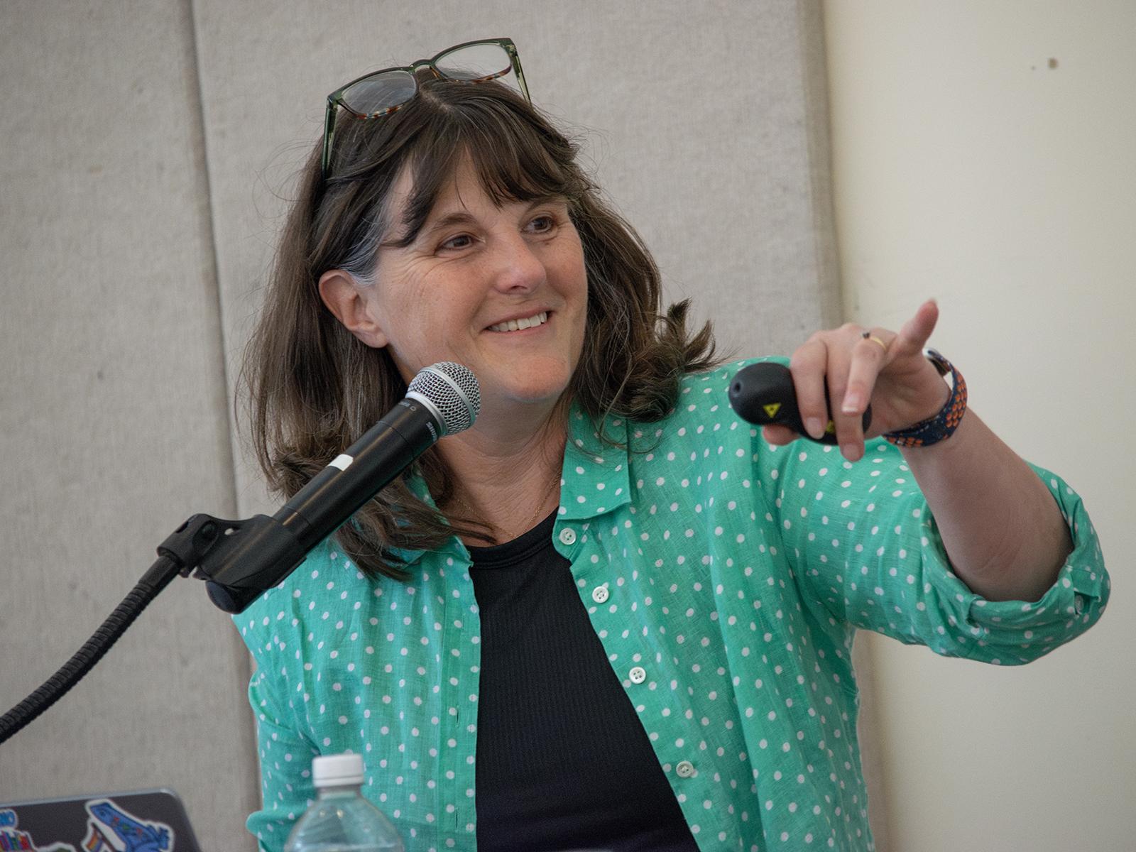 Kate Messner smiles and points to some to take a question during her presentation