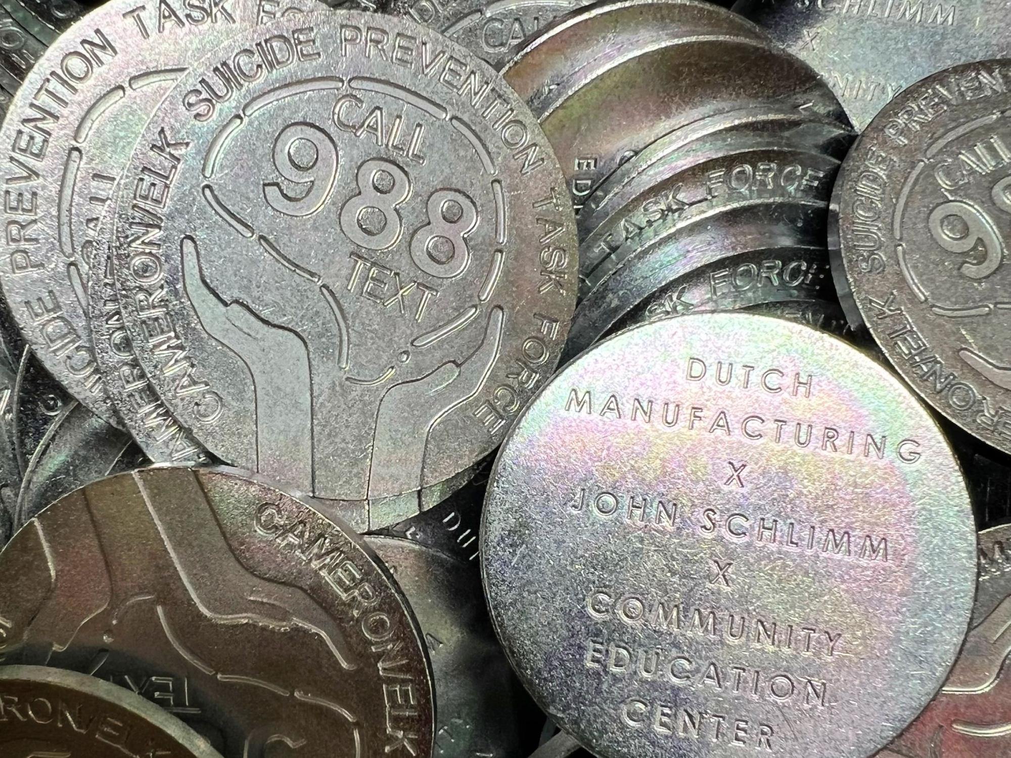 A close-up image showing both sides of the "988 coin"