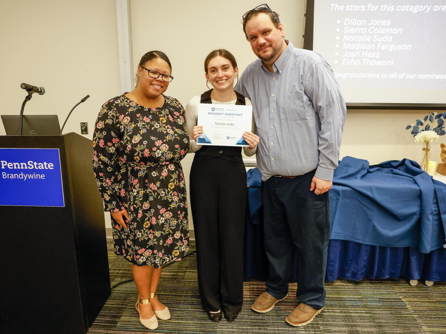student and staff members with award