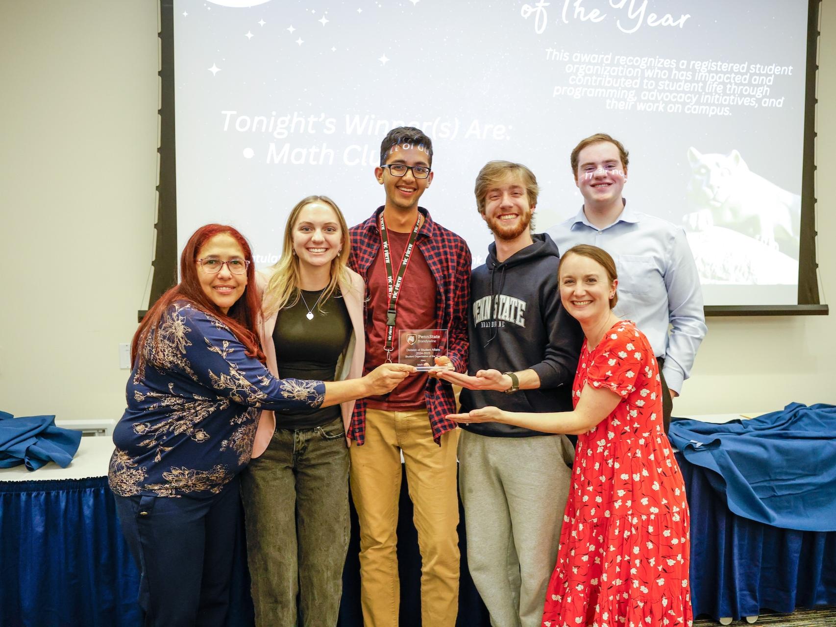 group of people holding award