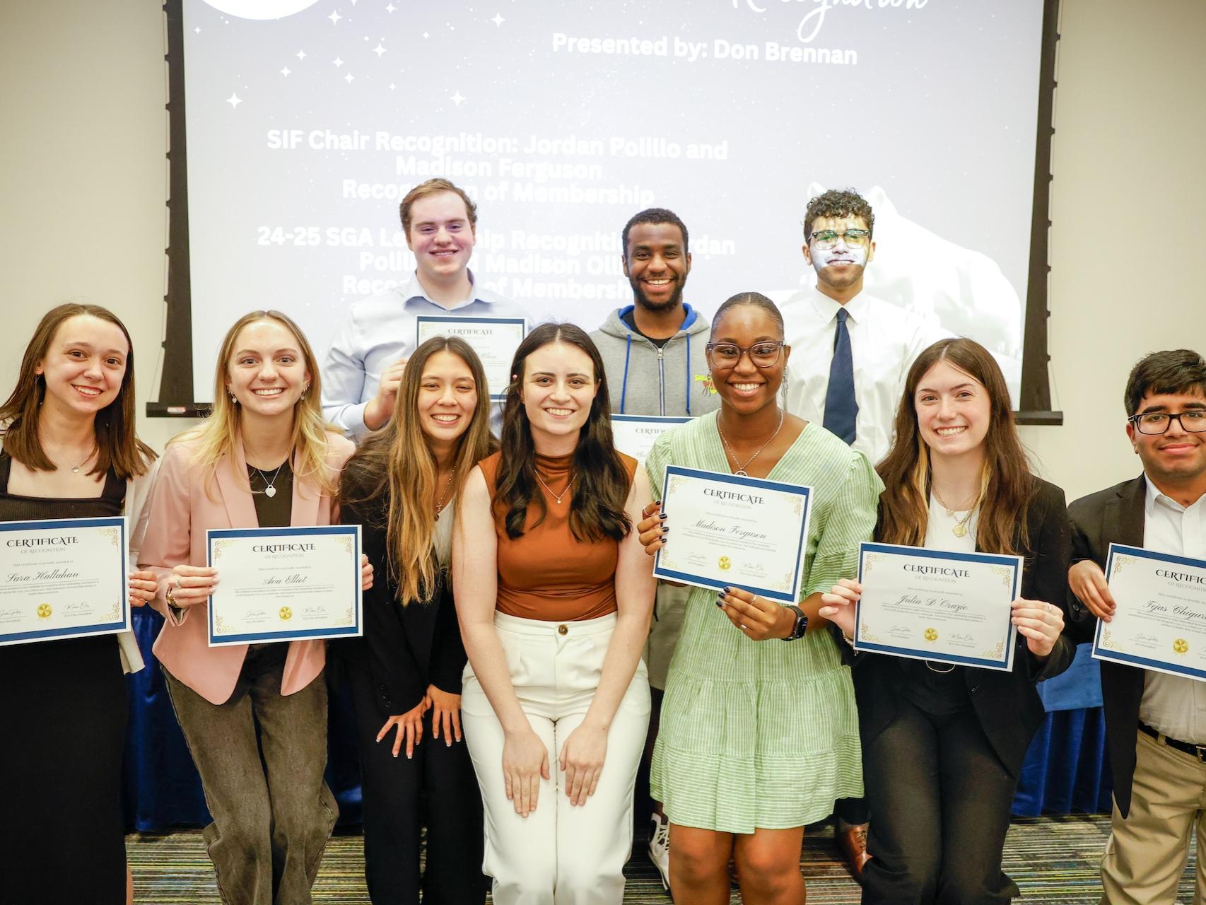 students holding certificates