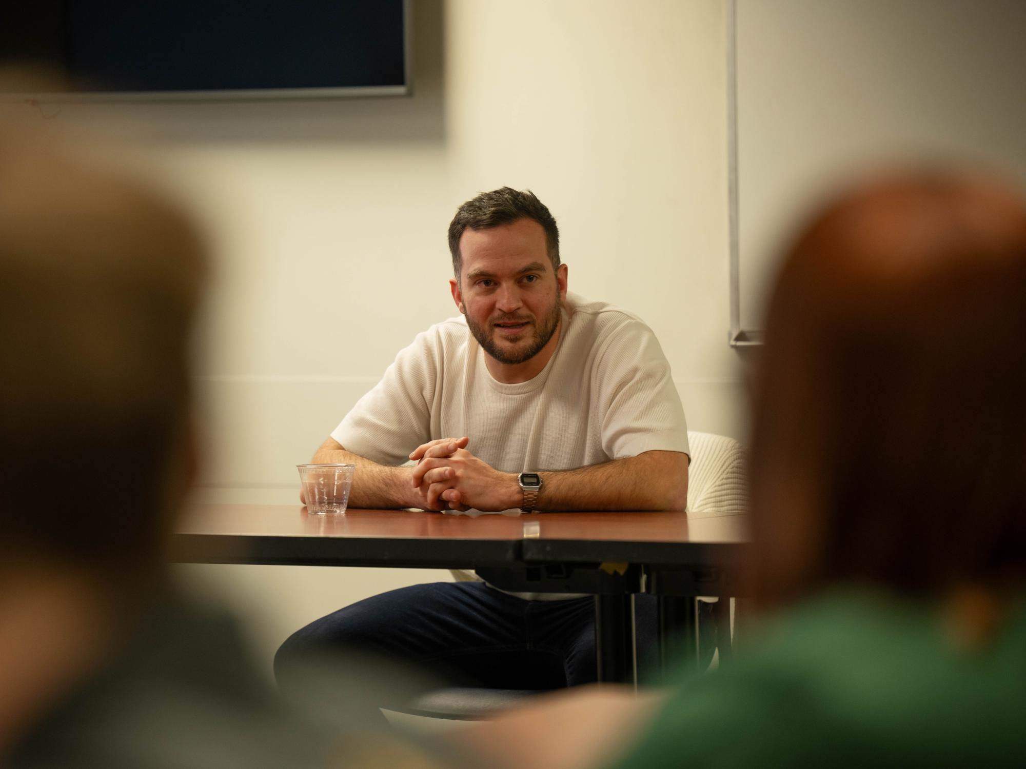 Penn State Behrend alumnus Connor Sattely talks with students in the Reed Union Building.