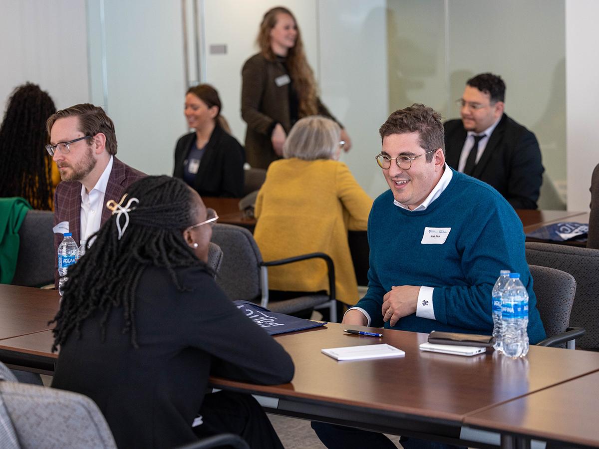 Penn State student speaking across the table with a Penn State alumnus about career paths.