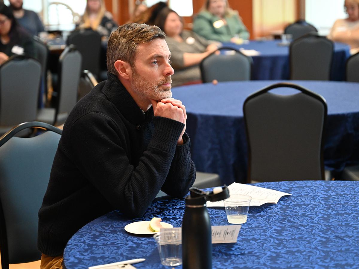 Ty Hollett seated at a table.