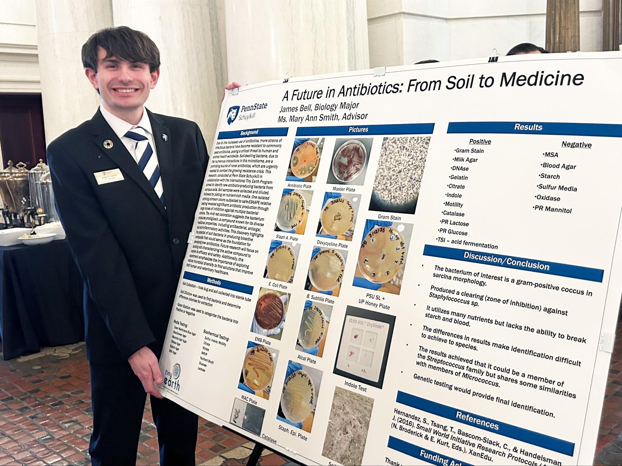 James Bell next to his poster