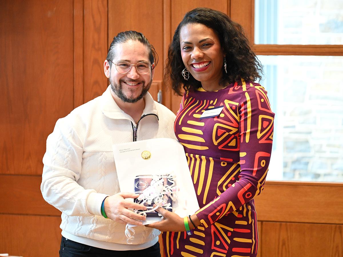 Efraín Marimón receives award from presenter Ashley Patterson.