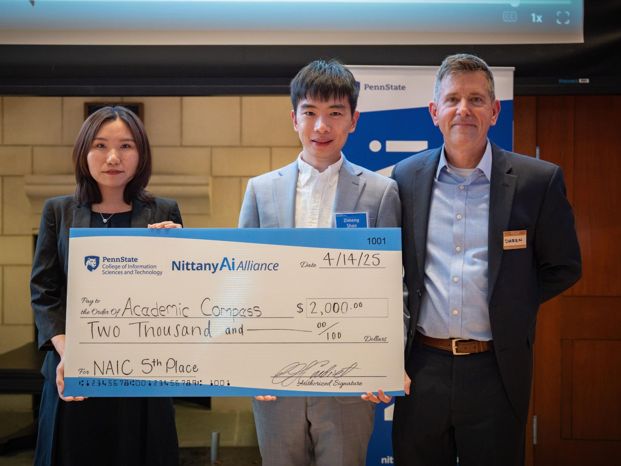 college students display giant check