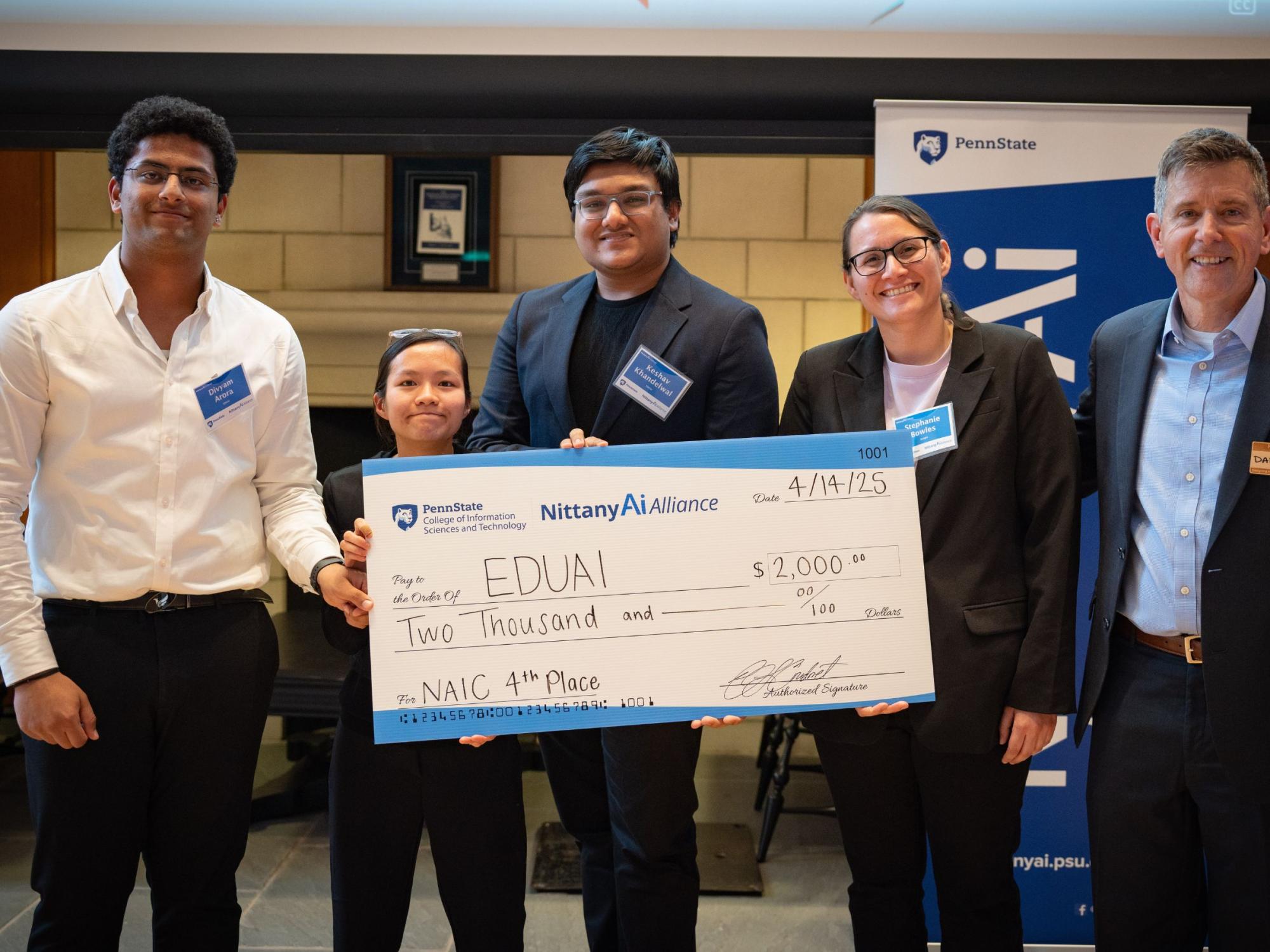 college students display giant check