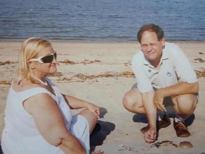 Older photo of a woman with blonde hair and a man with dark hair on the beach
