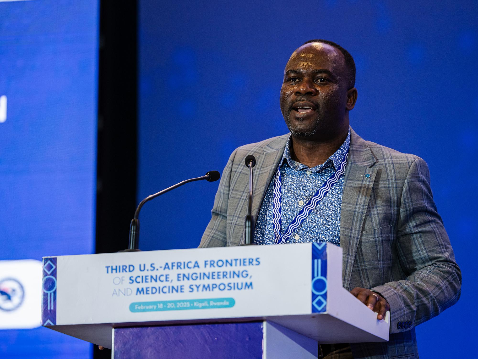 Nelson Dzade speaks at podium