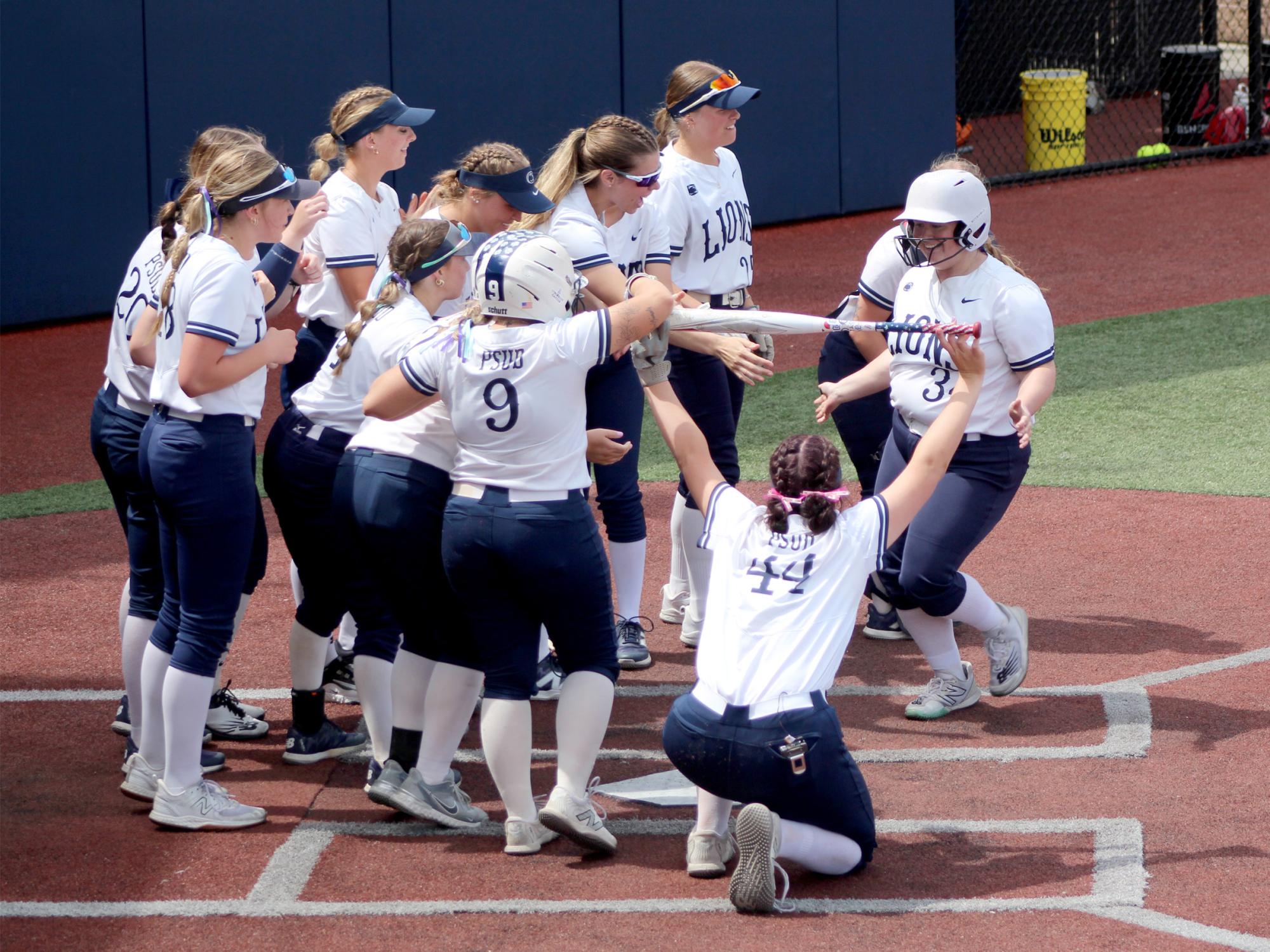 Penn State DuBois senior designated player Chelsea Busatto is congratulated by her teammates at home plate after hitting a home run during a game in the USCAA Small College World Series, held at Heindl Field in DuBois.
