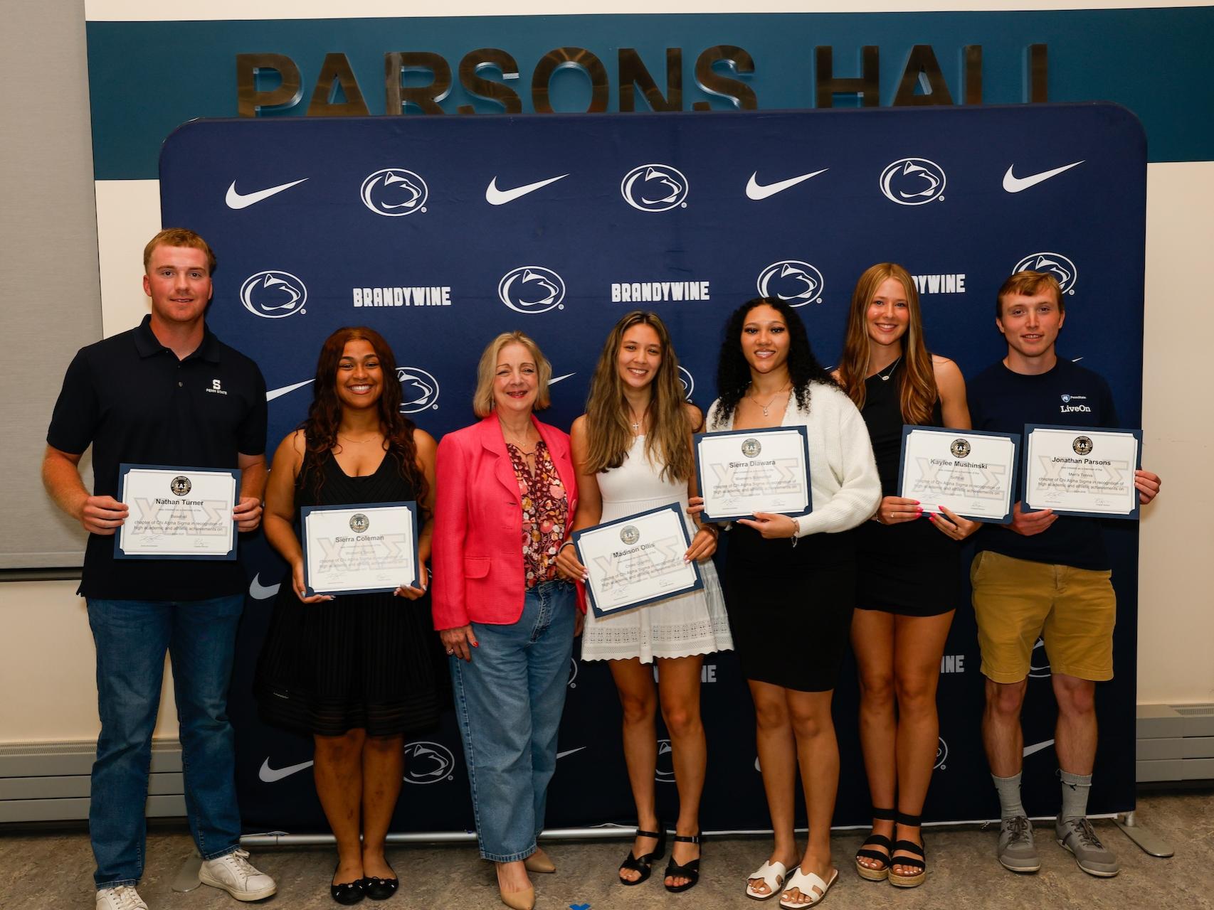 students with chancellor holding certificates