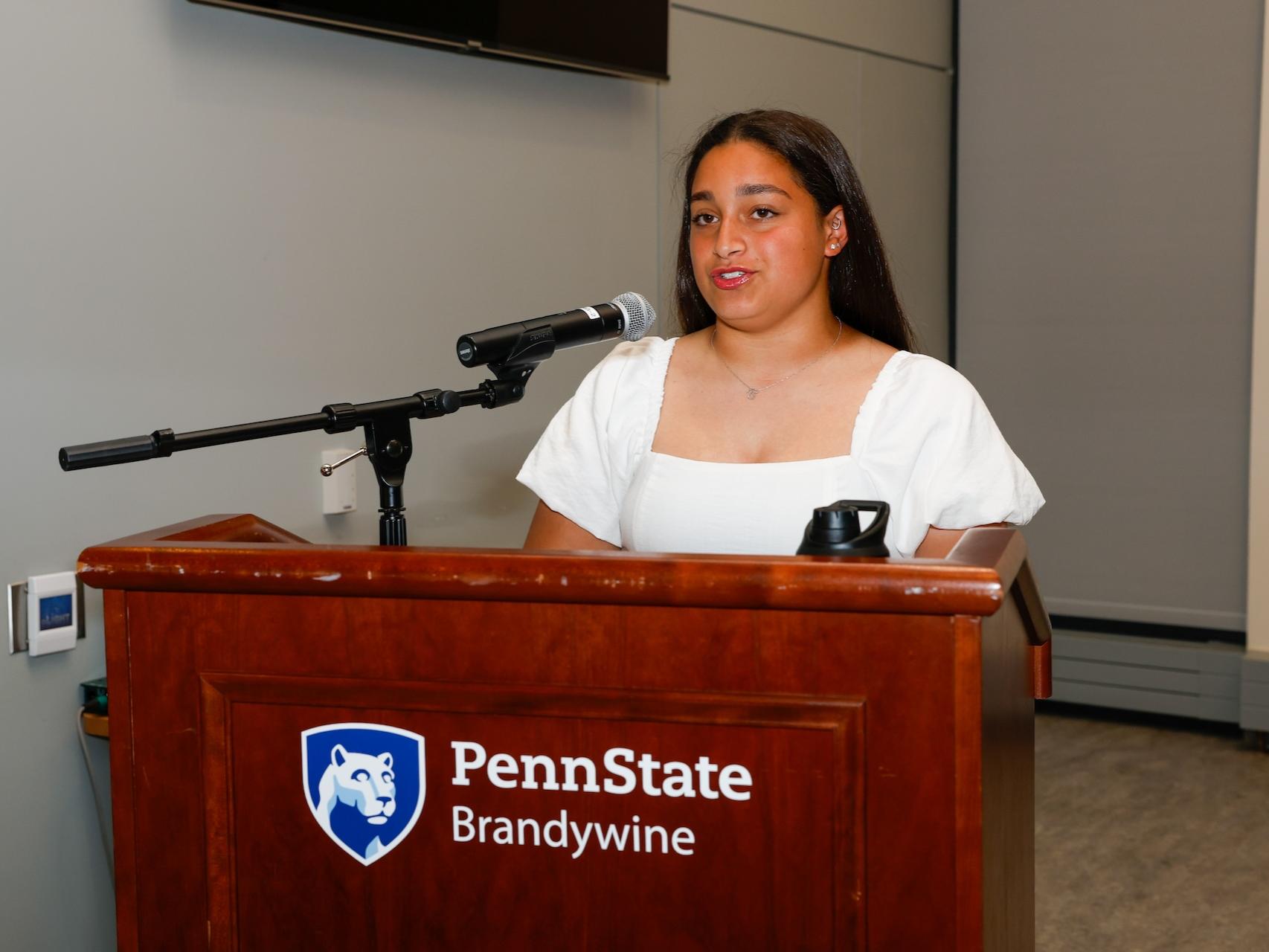 student talking at podium