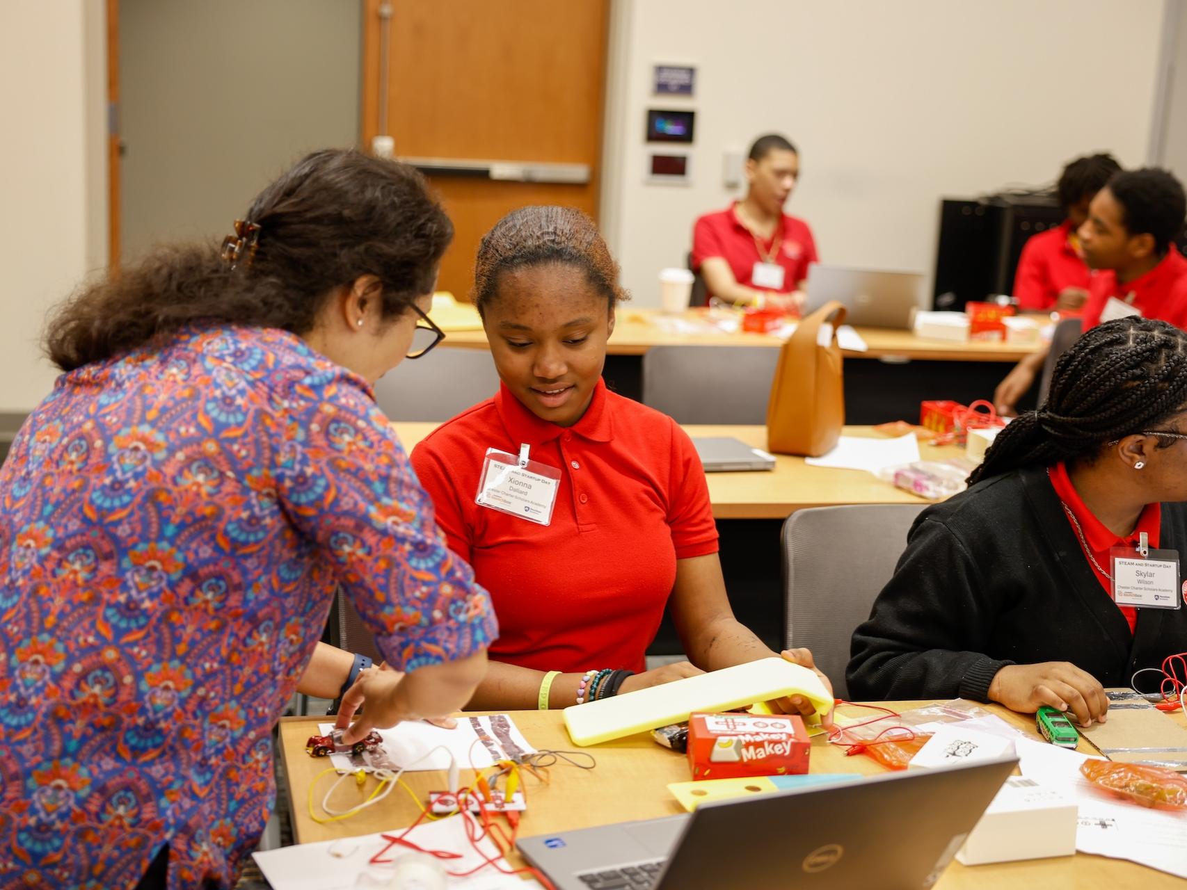 student with professor in a workshop