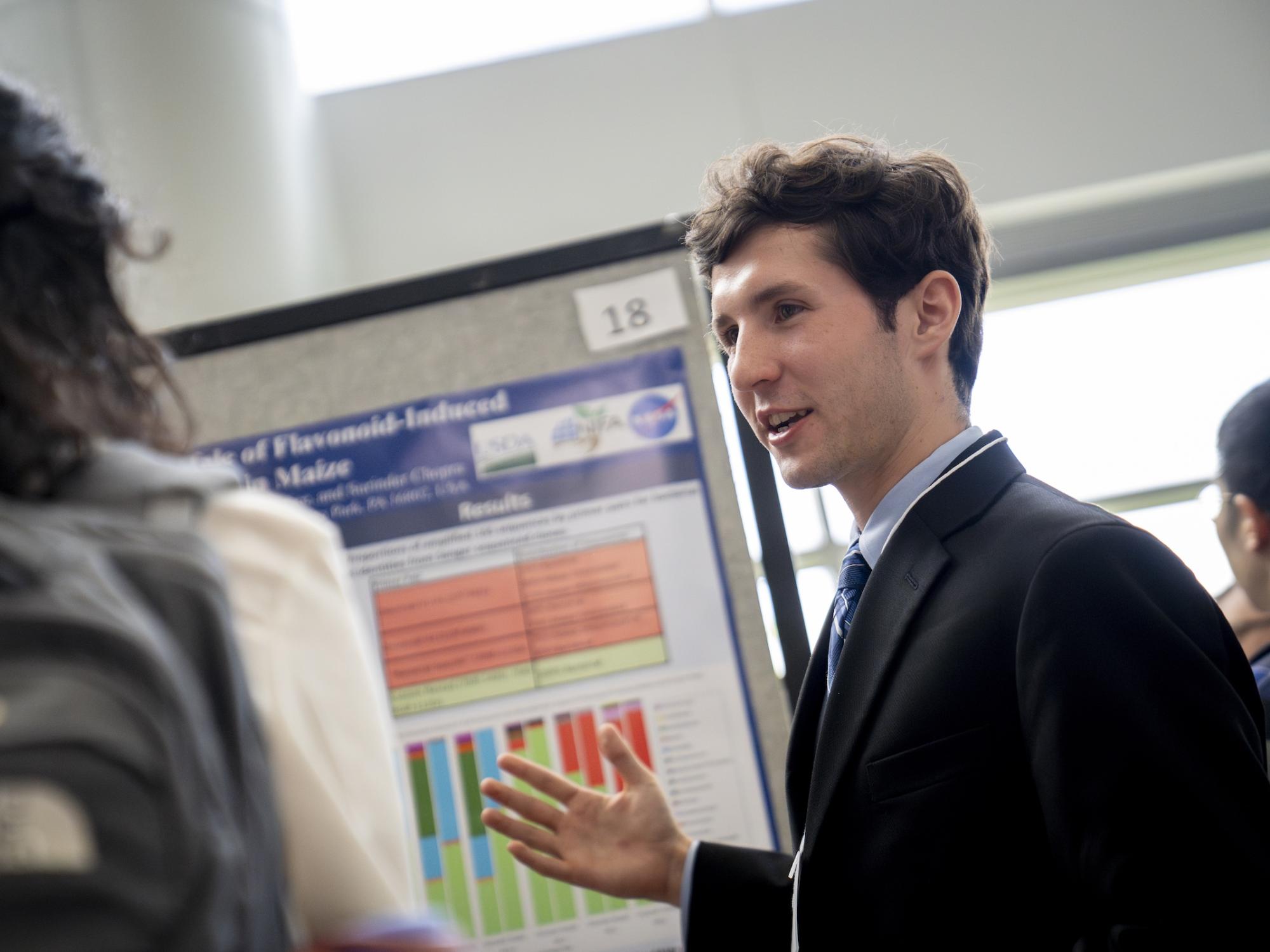 Charlie Colvin presenting a research poster