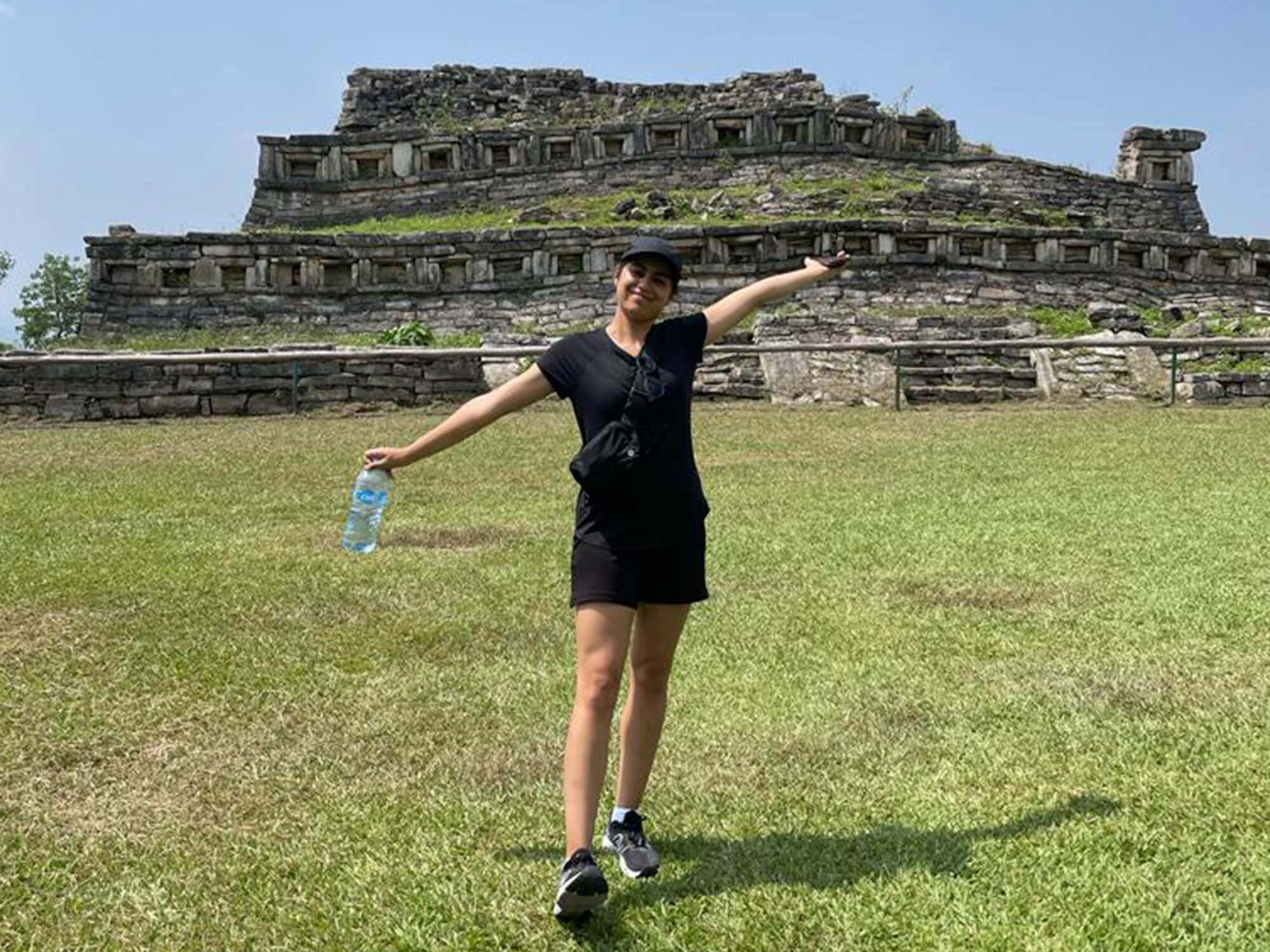Fiona Combs stands in front of ruins while studying abroad in Mexico.