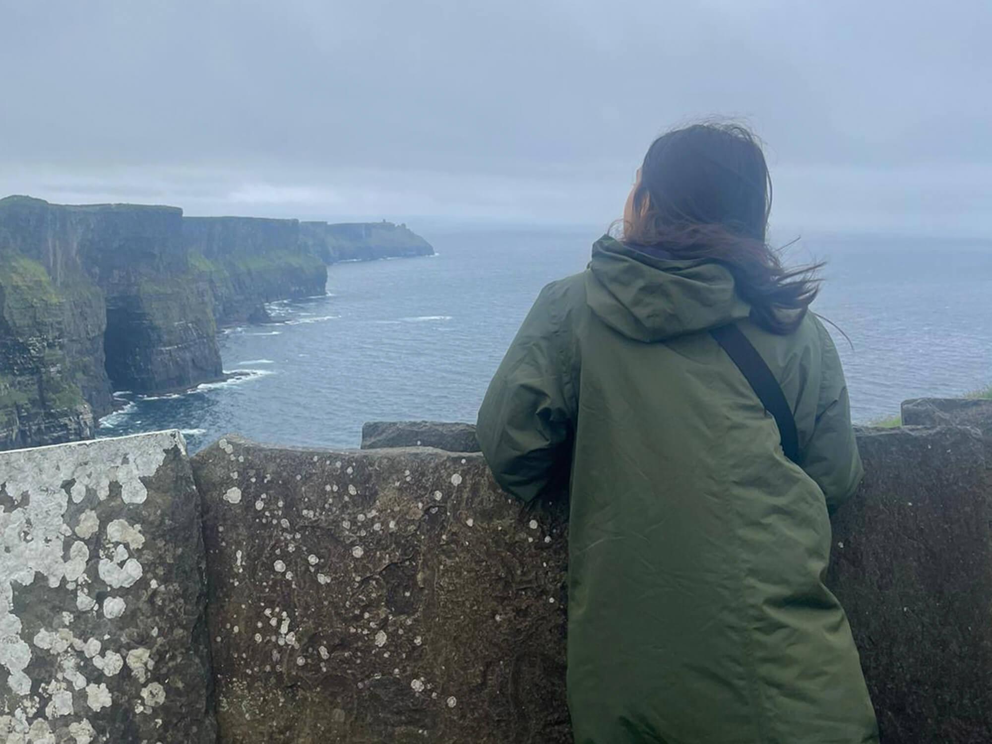 Fiona Combs looks out over the Cliffs of Moher while studying abroad in Ireland.