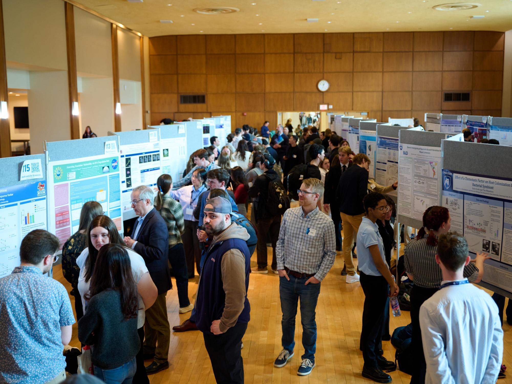 Overhead photo of busy poster exhibition in Alumni Hall