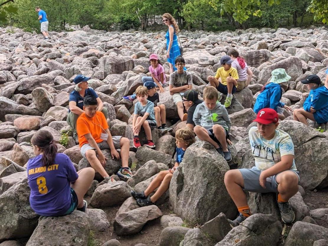 Master Watershed Steward Christine Boyle with students in the boulder field during water camp