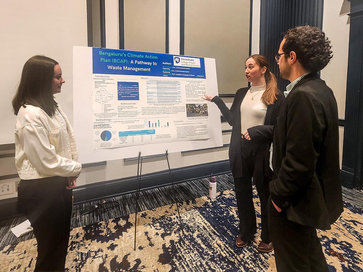  Undergraduate students Maria Catalano and Laura Hendry showcase their research poster on Bengaluru's waste management policy.