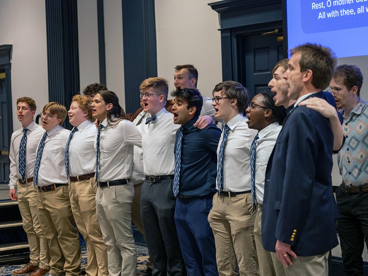 Photo of Penn State Glee Club leading audience in singing alma mater at Welch Ribbon Cutting ceremony