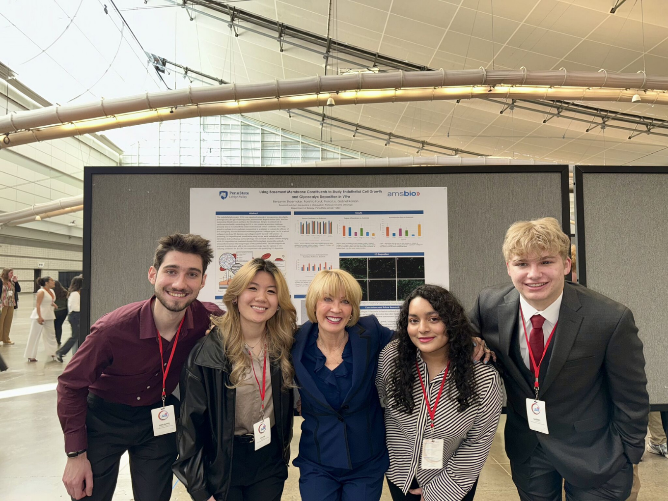 four biology students pose together at a conference