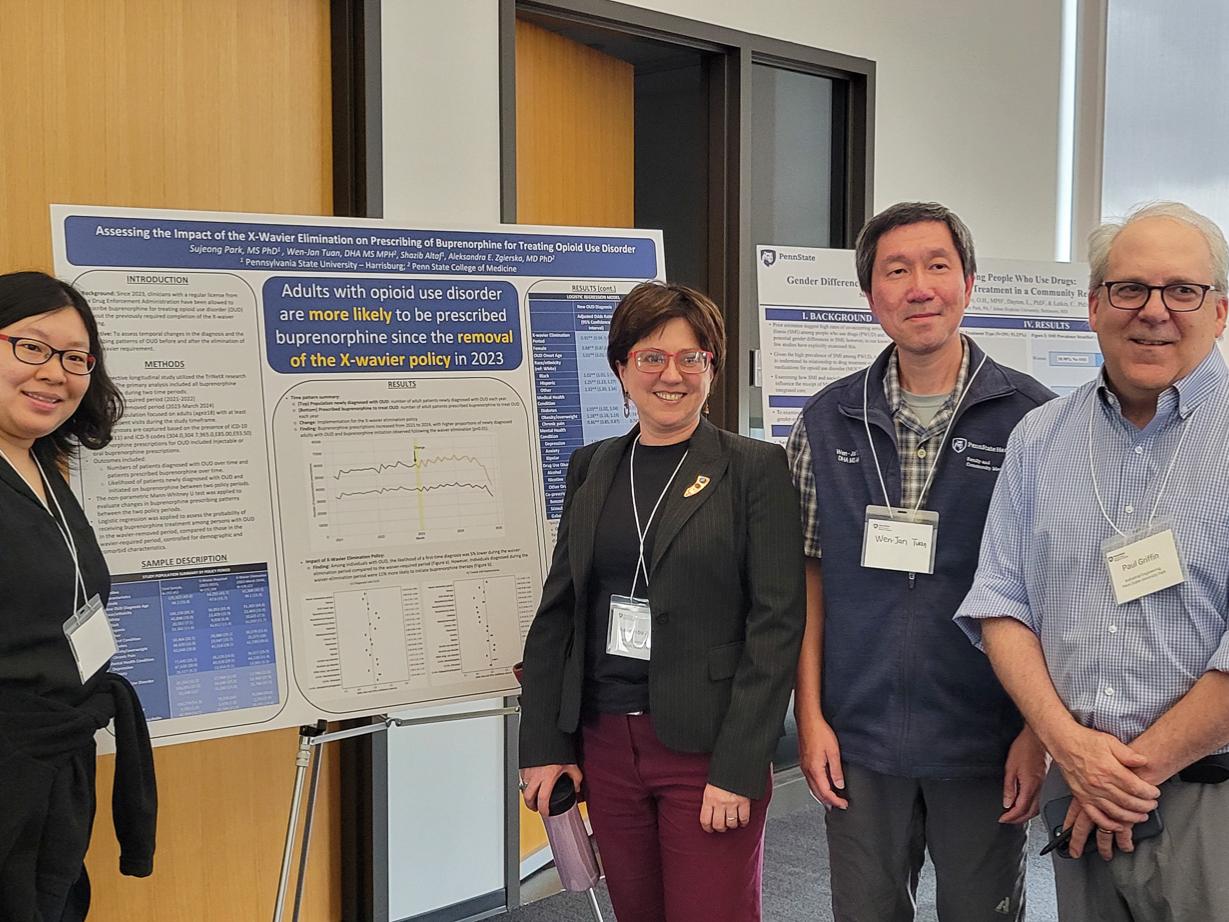CSUA conference attendees pose during the poster session.