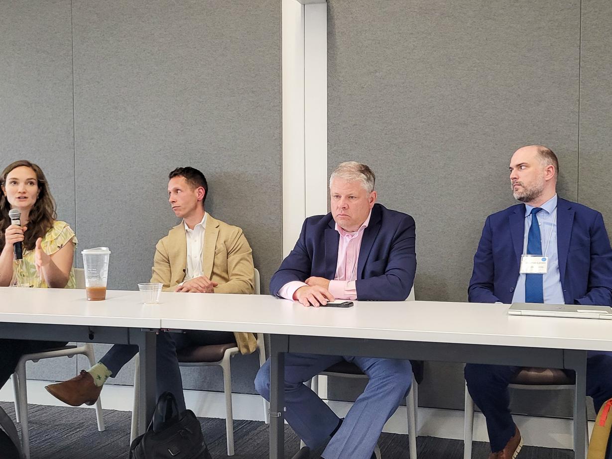 Four people sit at a panel in the Eric J. Barron Innovation Hub.