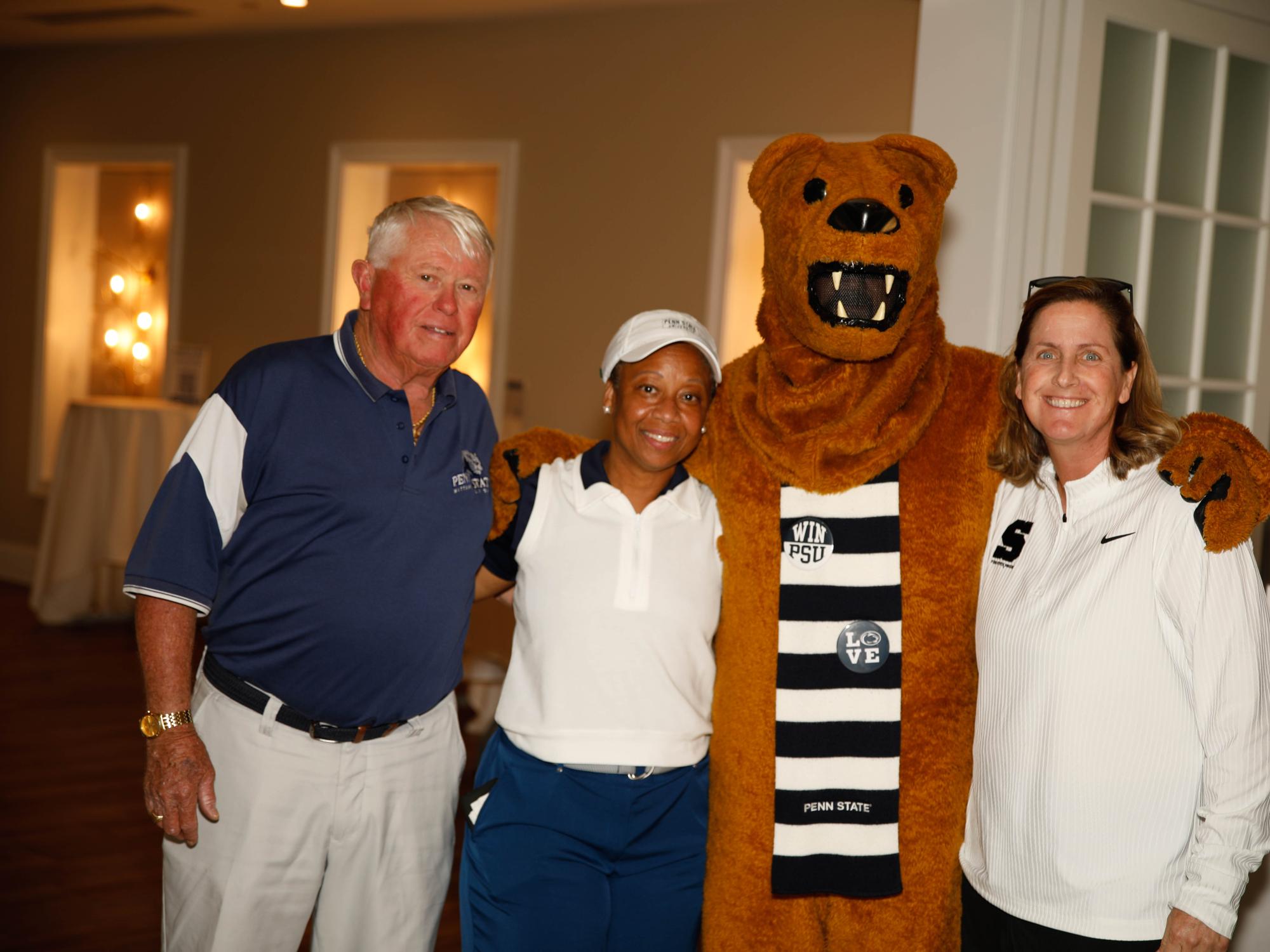 The Nittany Lion mascot poses with three attendees at the Penn State Great Valley golf outing.