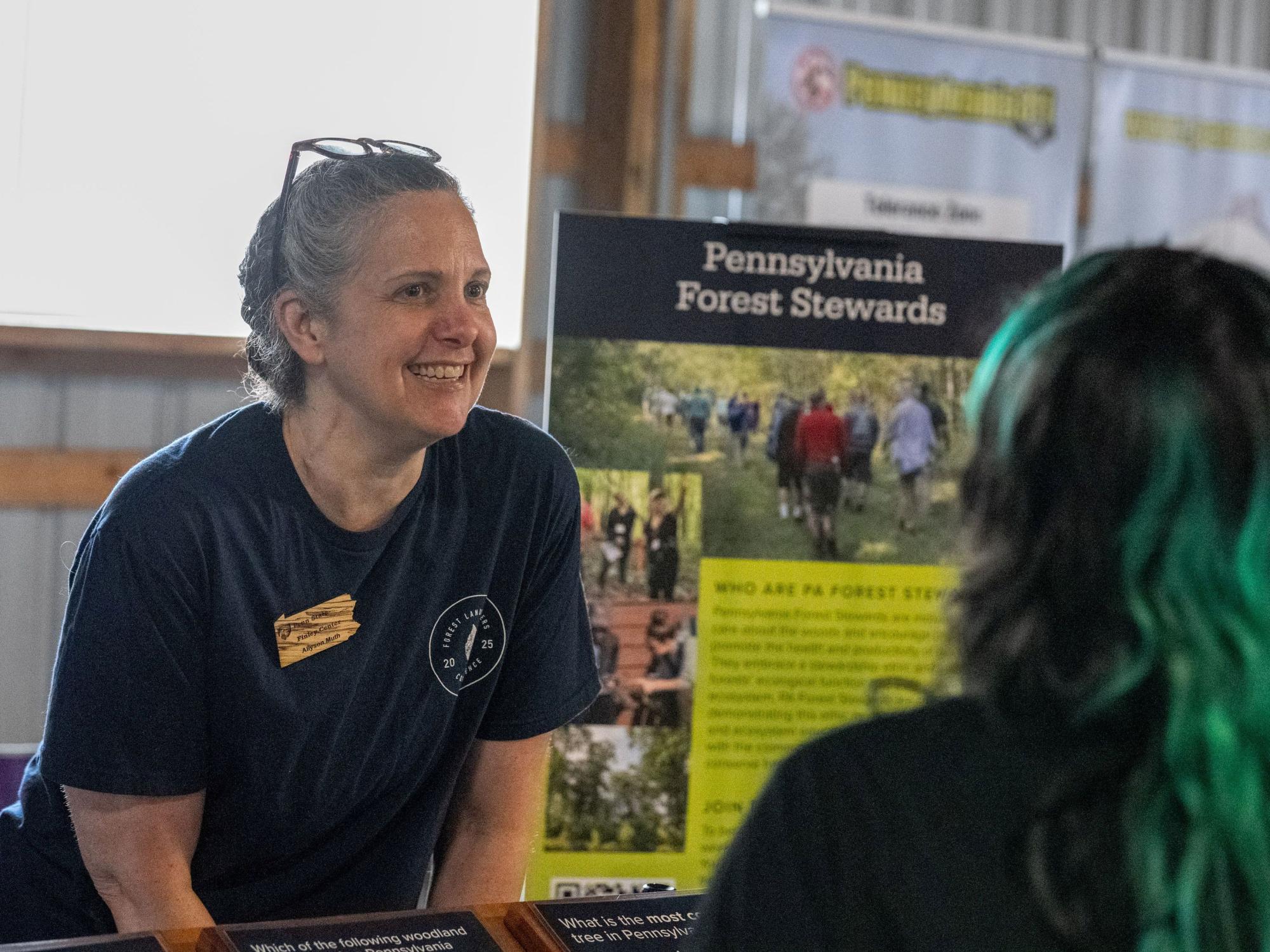 Center for Private Forests Director Allyson Muth talks to visitors at Timber 2025