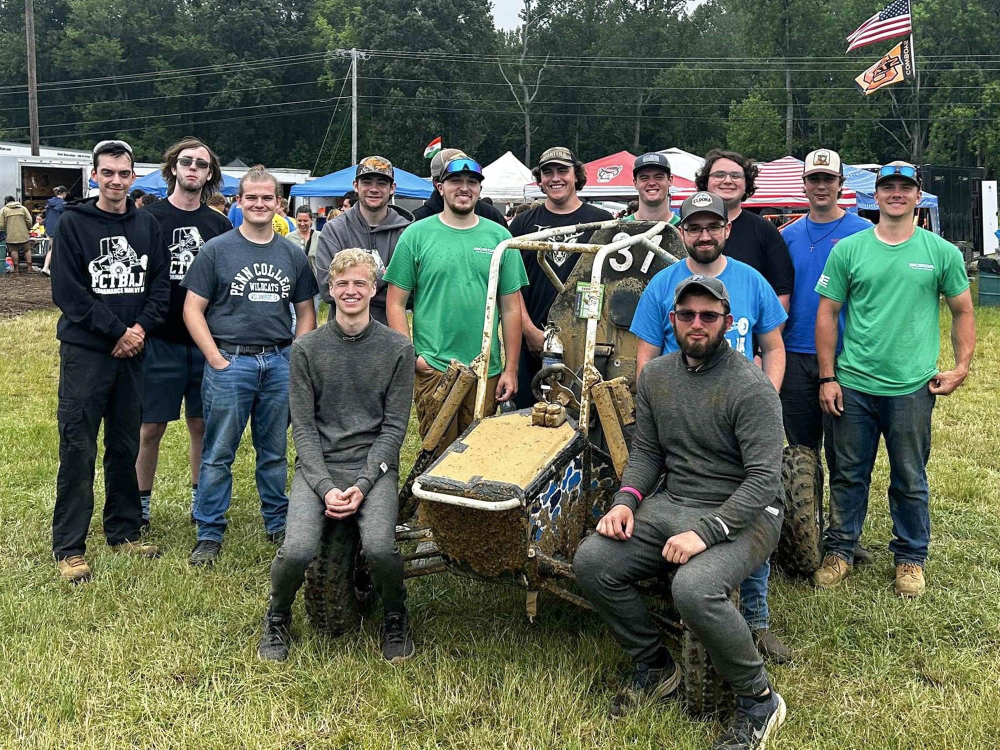Members of the Pennsylvania Baja SAE team celebrate with their car after a ninth-place finish out of 84 cars in the four-hour endurance race at Baja SAE Maryland. 