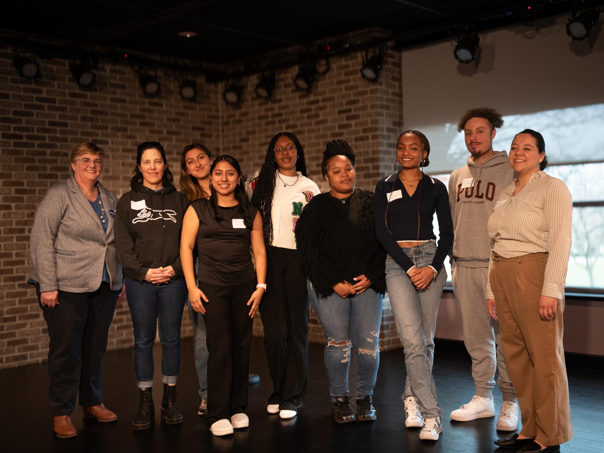 Iyana Burrows (fifth from the left) and five students and three staff smile during the Liberal Arts First-Gen Mixer. 