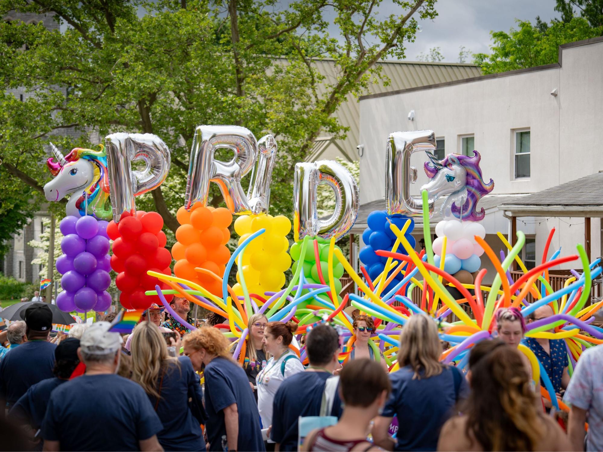 unicorn and pride balloons in parade