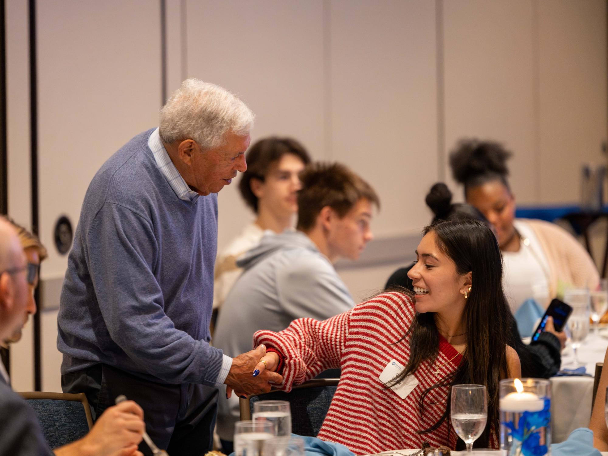 Diana Lopez shakes a man’s hand.