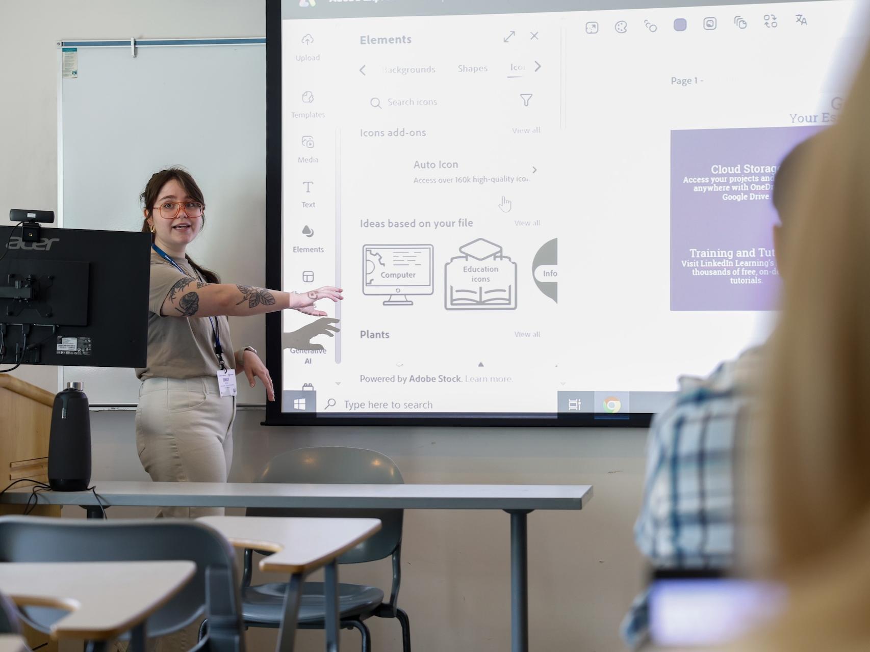 woman speaking and pointing at projector