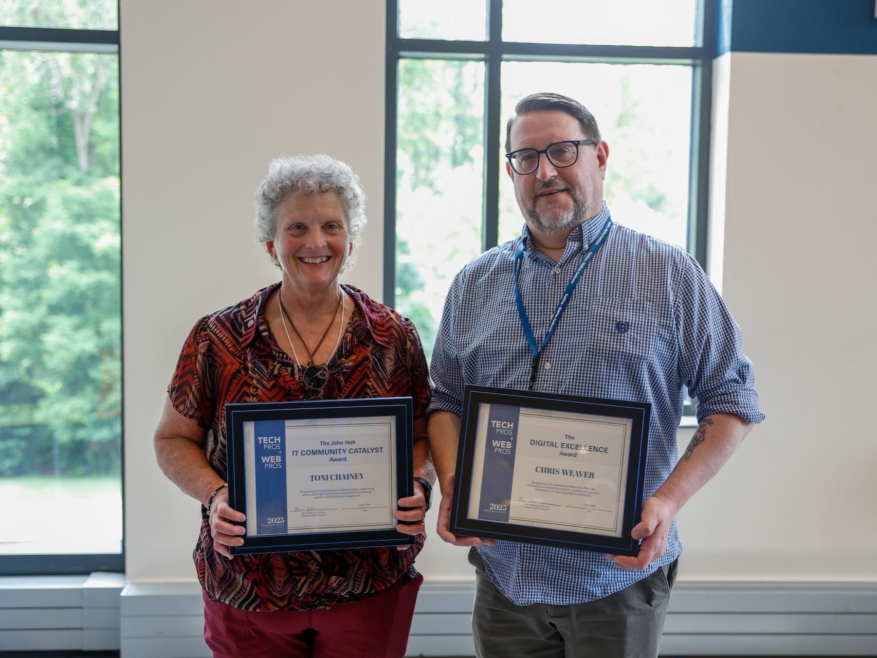 two people holding certificates