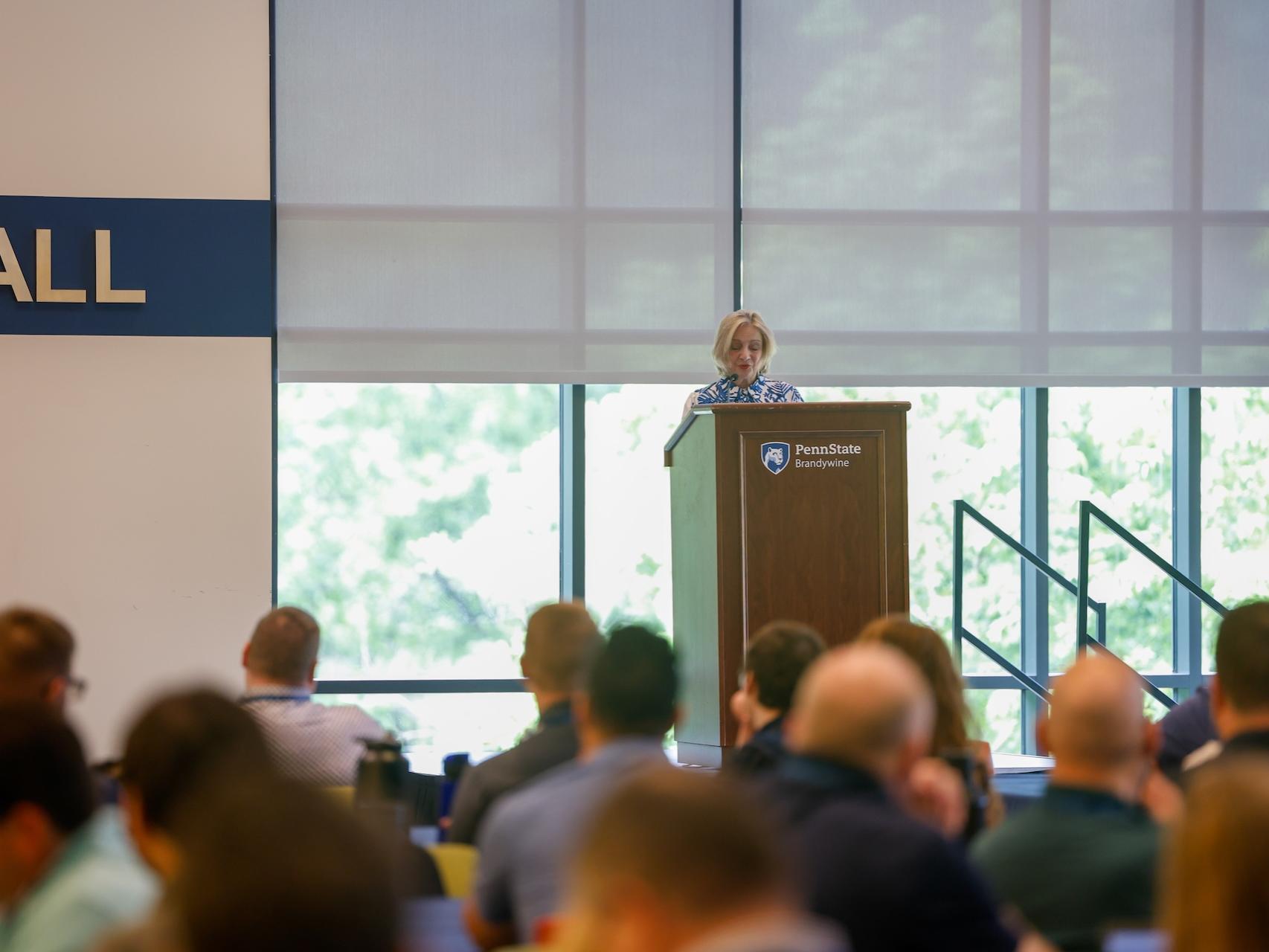 woman speaking at podium