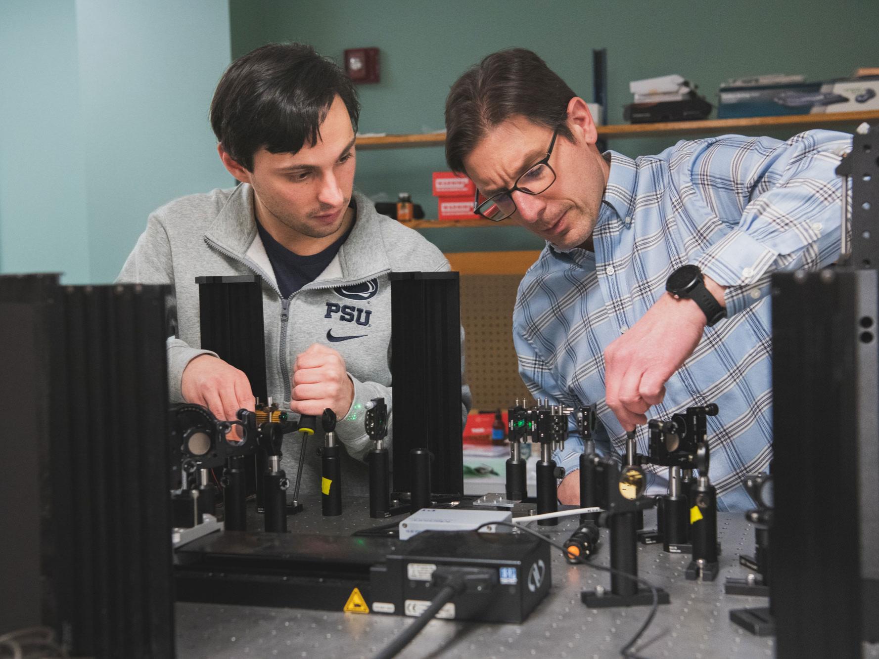 Ken Knappenberger and Daniel Heintzelman operate lab equipment