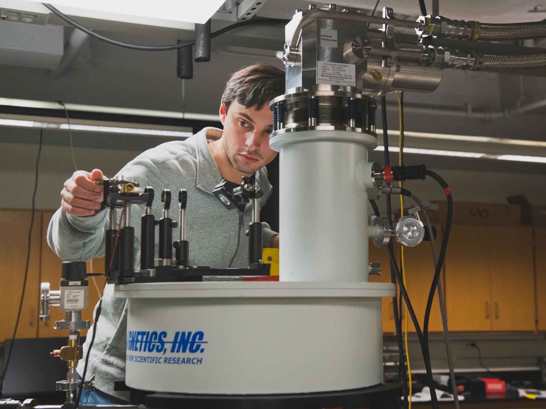 Daniel Heintzelman adjusts lab equipment