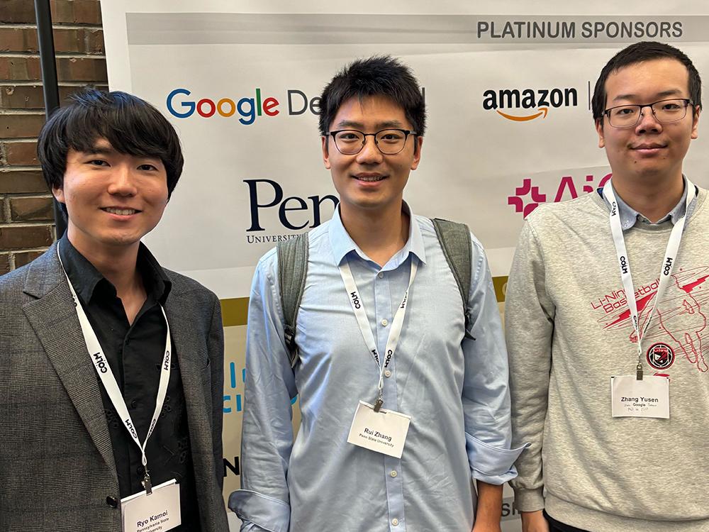 People smiling looking at the camera at a conference