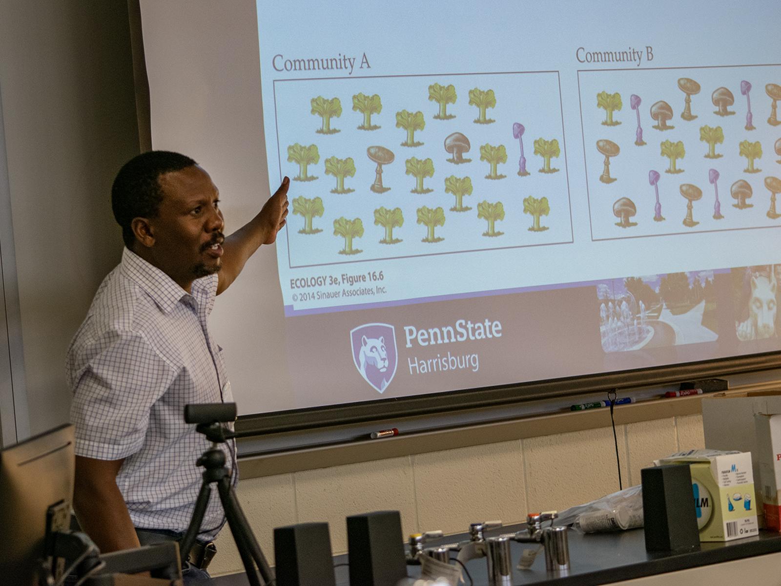 A professor points to images on a screen
