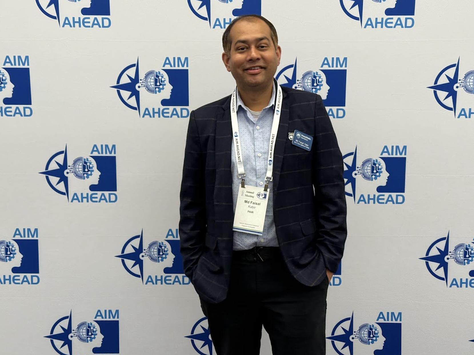 Md Faisal Kabir stands in front of an AIM AHEAD backdrop