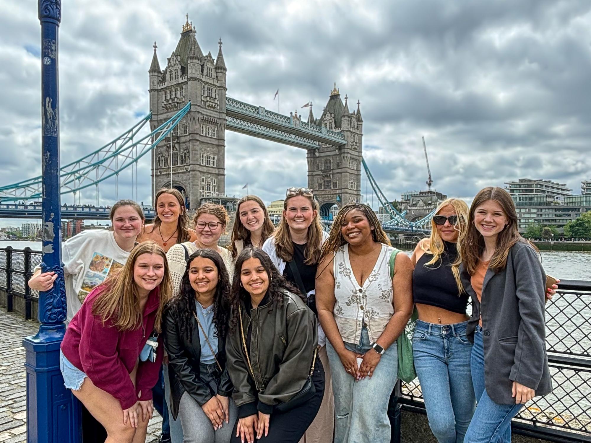 The Kayani sisters and fellow Penn State students taking part in a Maymester program in London, with Tower Bridge outside the Tower of London in the background.