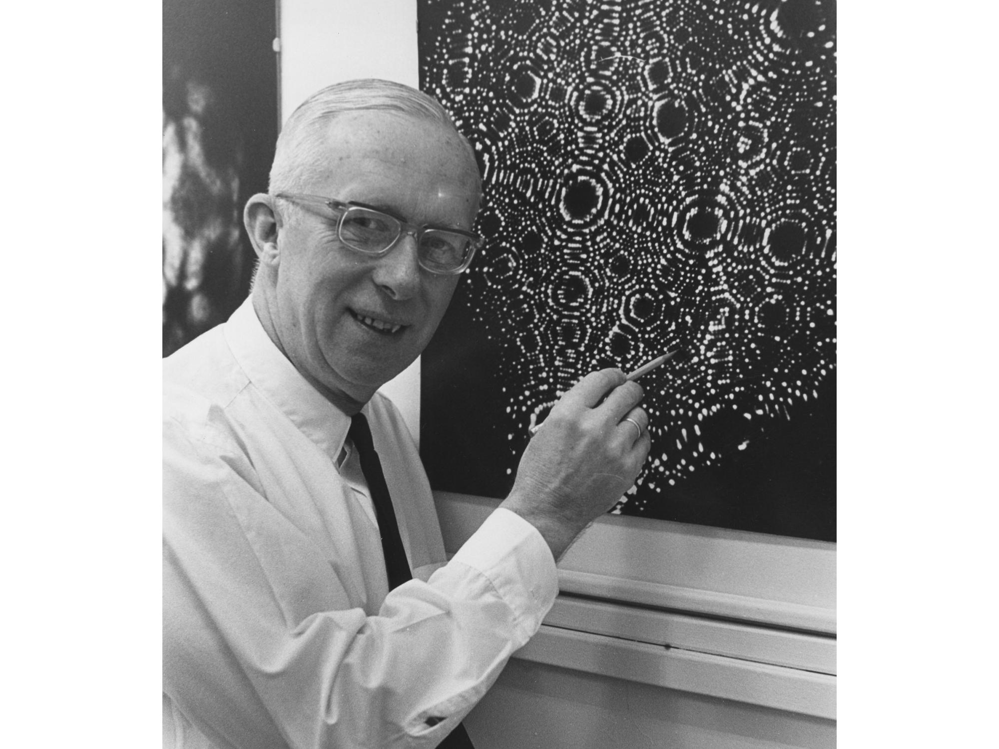 researcher showing an image taken with a microscope