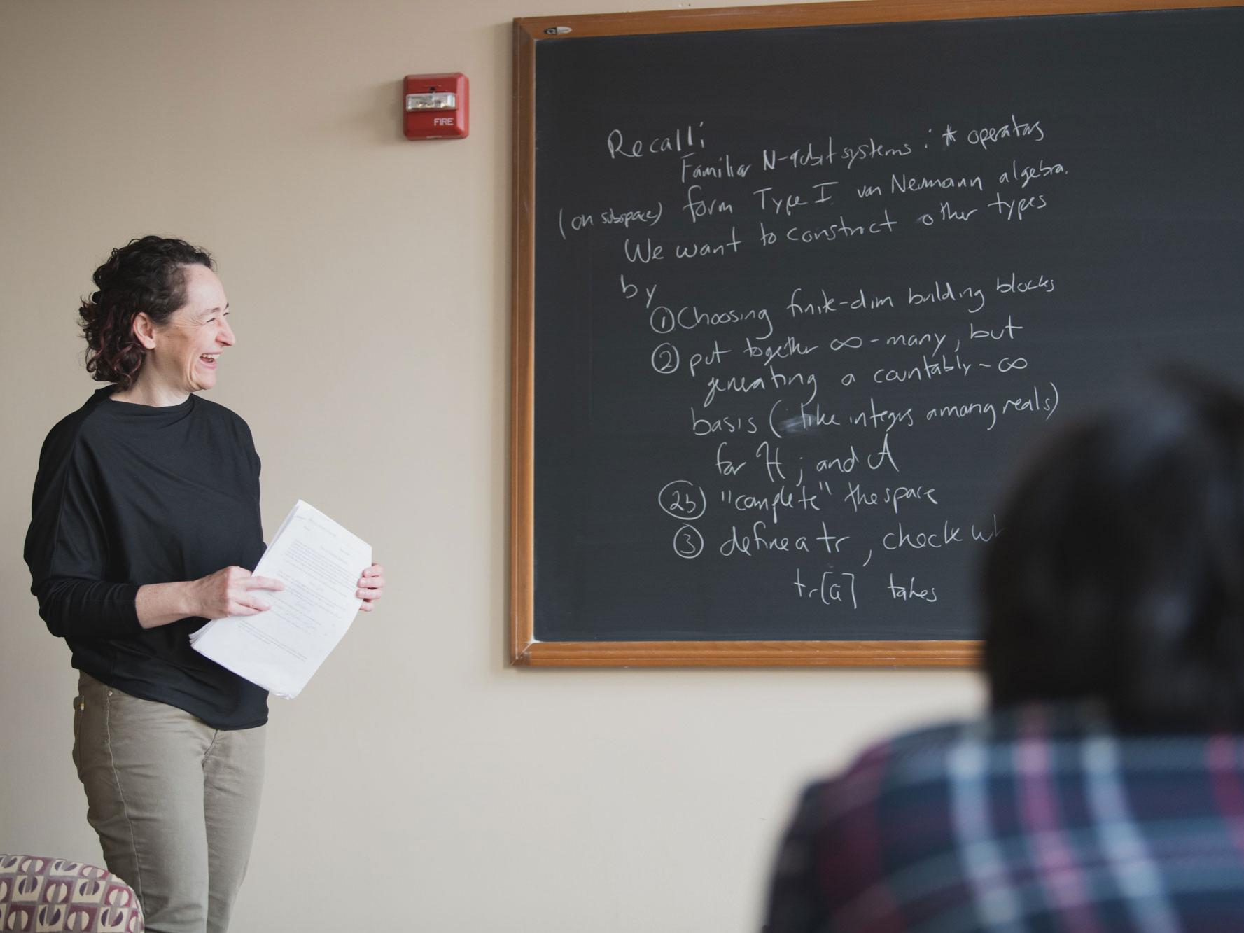 Shara Shandera looks at chalk board
