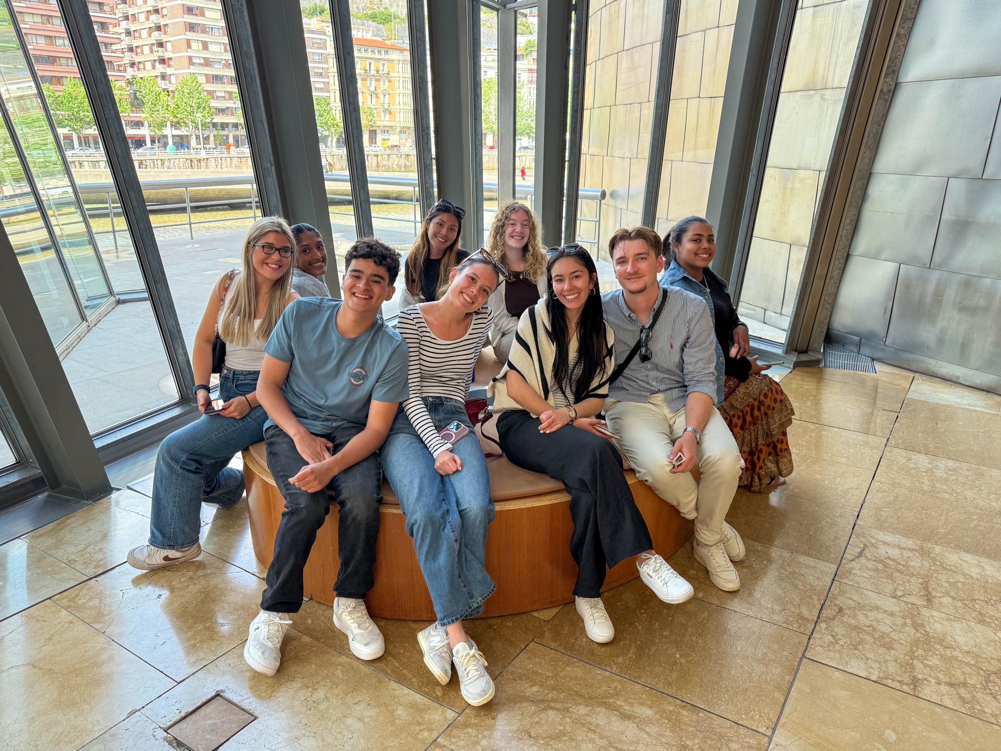 Nine Penn State students sit inside the Guggenheim Museum in Bilbao, Spain.