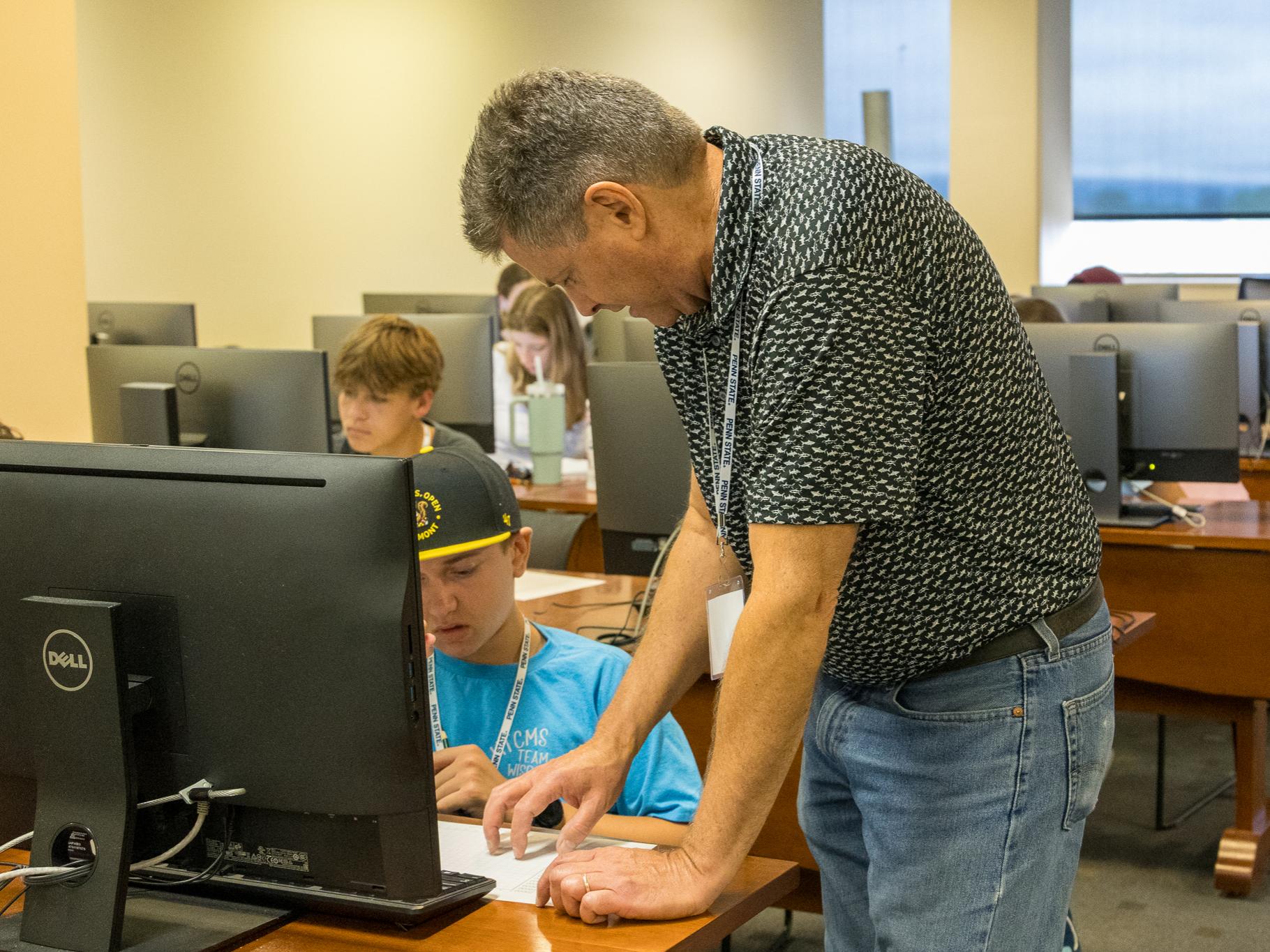 William Syrett helps a student