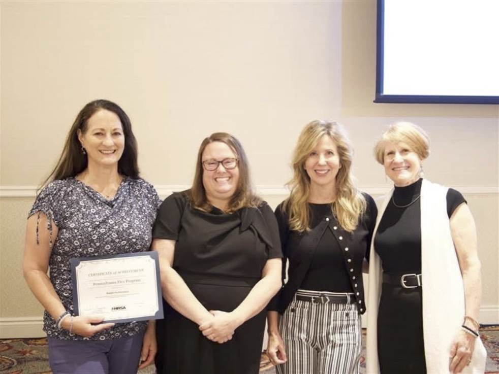 Standing from L>R: Lannette Fetzer, Sarah Heppner, Sandee Kyler, and Lisa Davis with award 